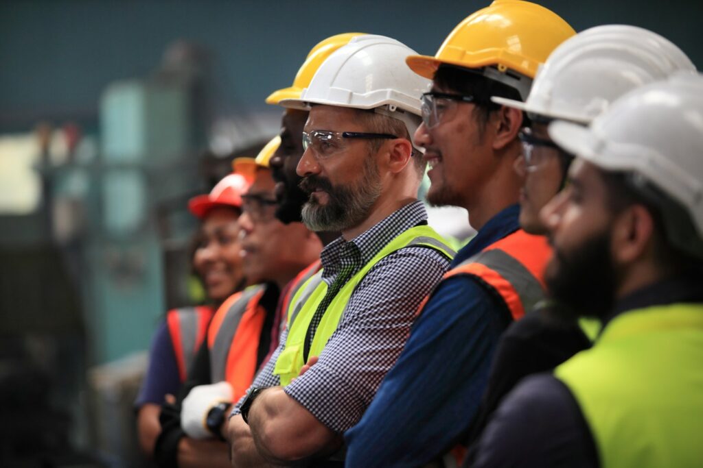Construction workers wearing hard hats standing in a line